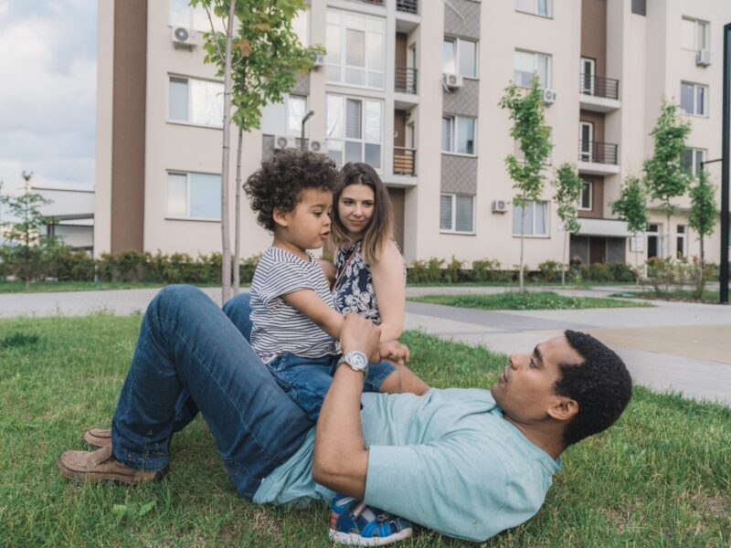 Family playing outside apartment