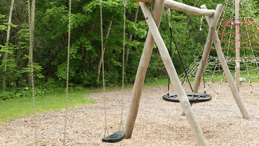 Swings on outdoor wooden playground
